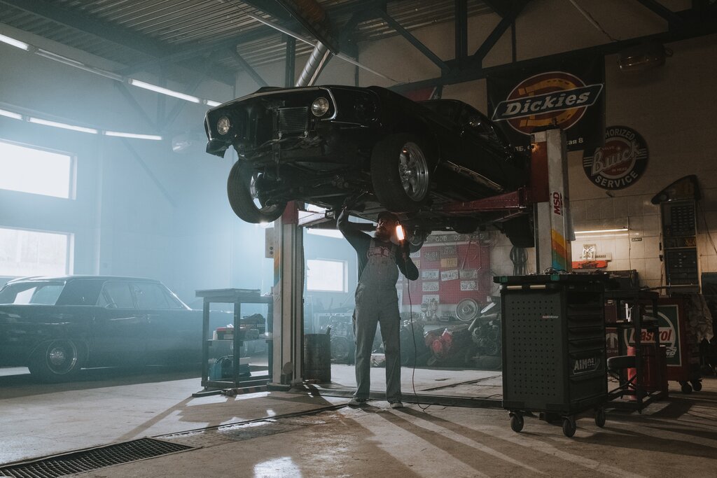 Man doing repair work on a car.