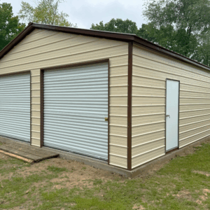 Pebble beige two-car metal garage with earth brown trim, white roll-up doors, and a side walk-in door, installed in Albany, KY by American Steel Carports, Inc.