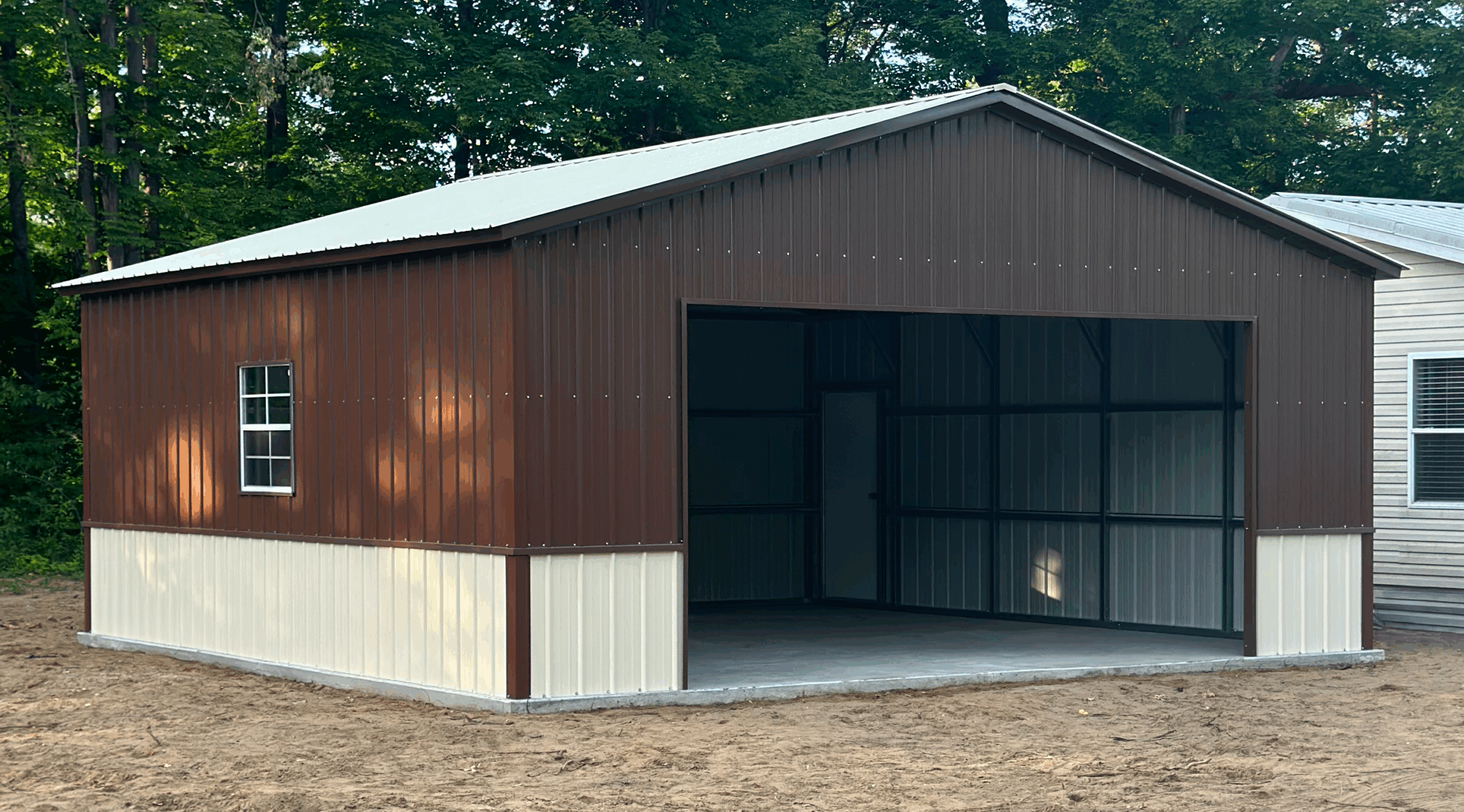 Opposite side profile of a two-tone steel garage in Ames, IA with vertical siding and framed structure.