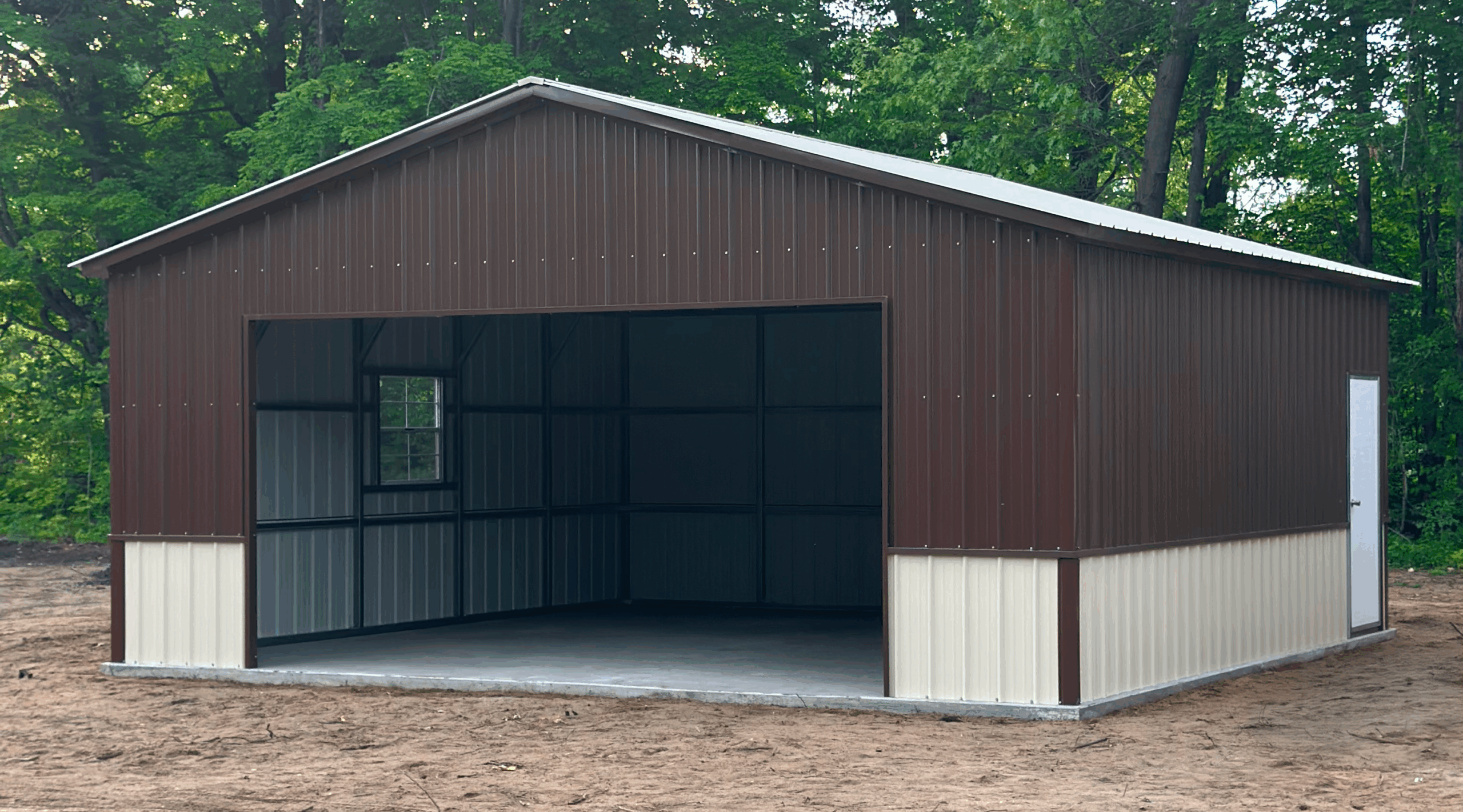 Side view of a earth brown and pebble beige metal garage in Ames, IA with vertical steel panels and a concrete foundation.