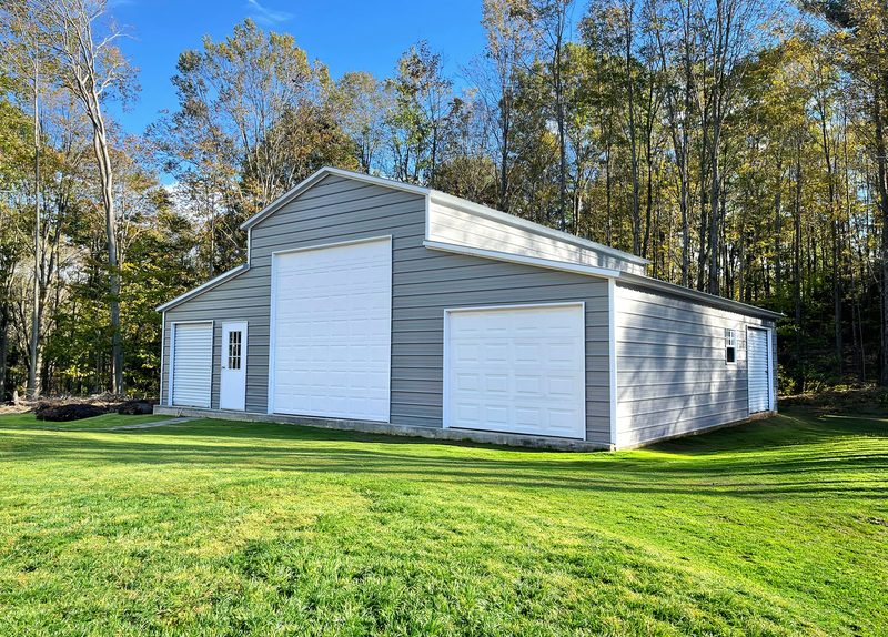 White steel barn with two roll-up doors