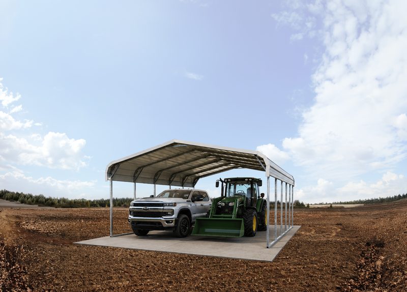 Standard steel carport covering a truck and tractor